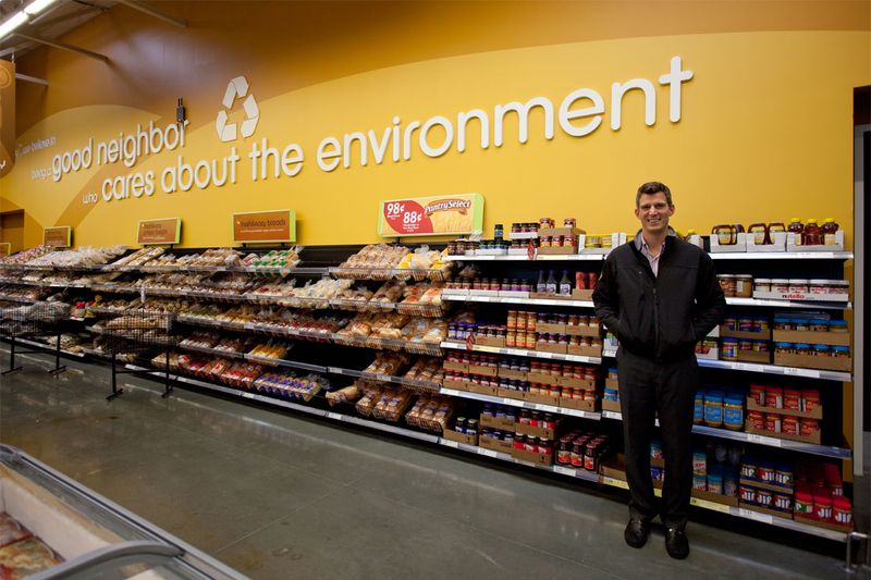Fresh & Easy Store in Compton, California: Director of Neighborhood Affairs Roberto Munoz shows off the finished concrete floor, company messages to the customers, and shelving displays within arm’s easy reach.