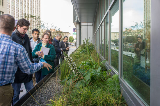 John Scarpulla of the San Francisco Public Utilities Commission explained how the sidewalk landscaping planter works as a tidal flow wetland while he led a tour of the SFPUC Headquarters for the Net Positive Energy and Water Conference attendees. (Photo by Mignon O’Young)