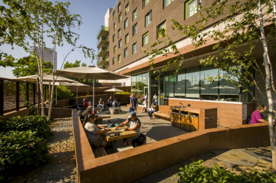 Bud Clark Commons' public courtyard, sheltered from the traffic and street, provides a safe and dignified place for homeless individuals seeking services to wait, socialize, and experience nature within an urban environment. (Photo by Bruce Forster)