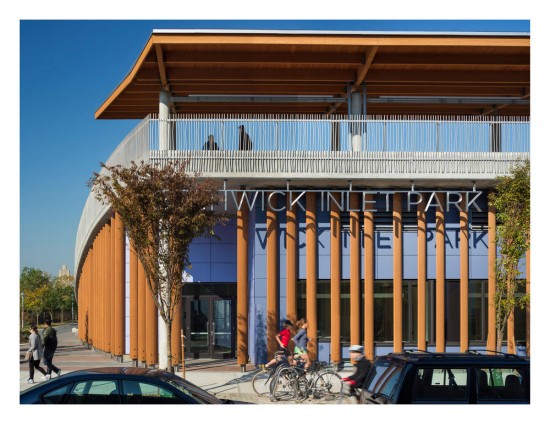 View of Community Center entrance at Bushwick Inlet Park in Brooklyn, New York, showing wood louvers and rooftop canopy, phenolic panel rainscreens and custom stainless steel railings. (Photo by Paul Warchol)
