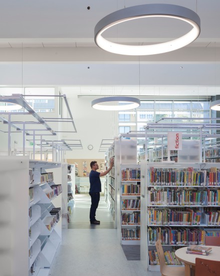 Lighting for the book stacks in the West Berkeley Public Library comes from built-in energy efficient light fixtures above the stacks rather than relying on general ambient lighting. (Photo by Mark Luthringer)
