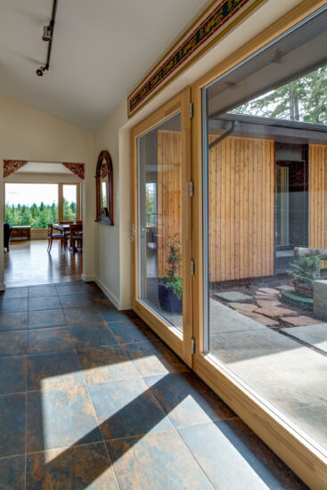Pumpkin Ridge Passive House's strategic placement of glass brings the outdoors into the home.  (Photo by Jeff Amram)