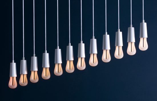A row of Plumen 002 LED bulbs showing the range of dimmability. (Photo courtesy Plumen)
