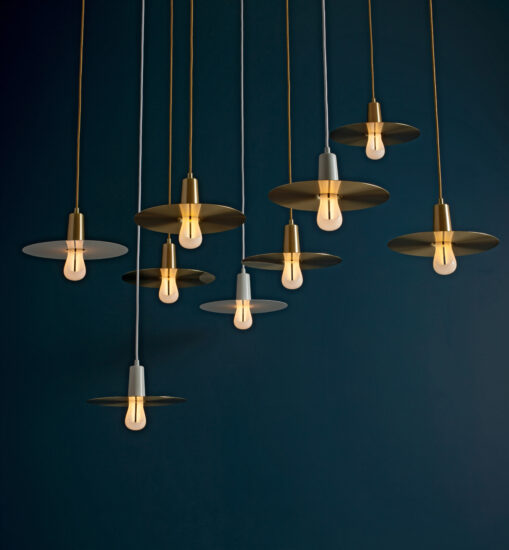 Multiple Plumen 002 LED bulbs complimented by drop hat lamp shades together make for an elegant chandelier which gives the sculptural bulbs a whole different feeling. (Photo courtesy Plumen)