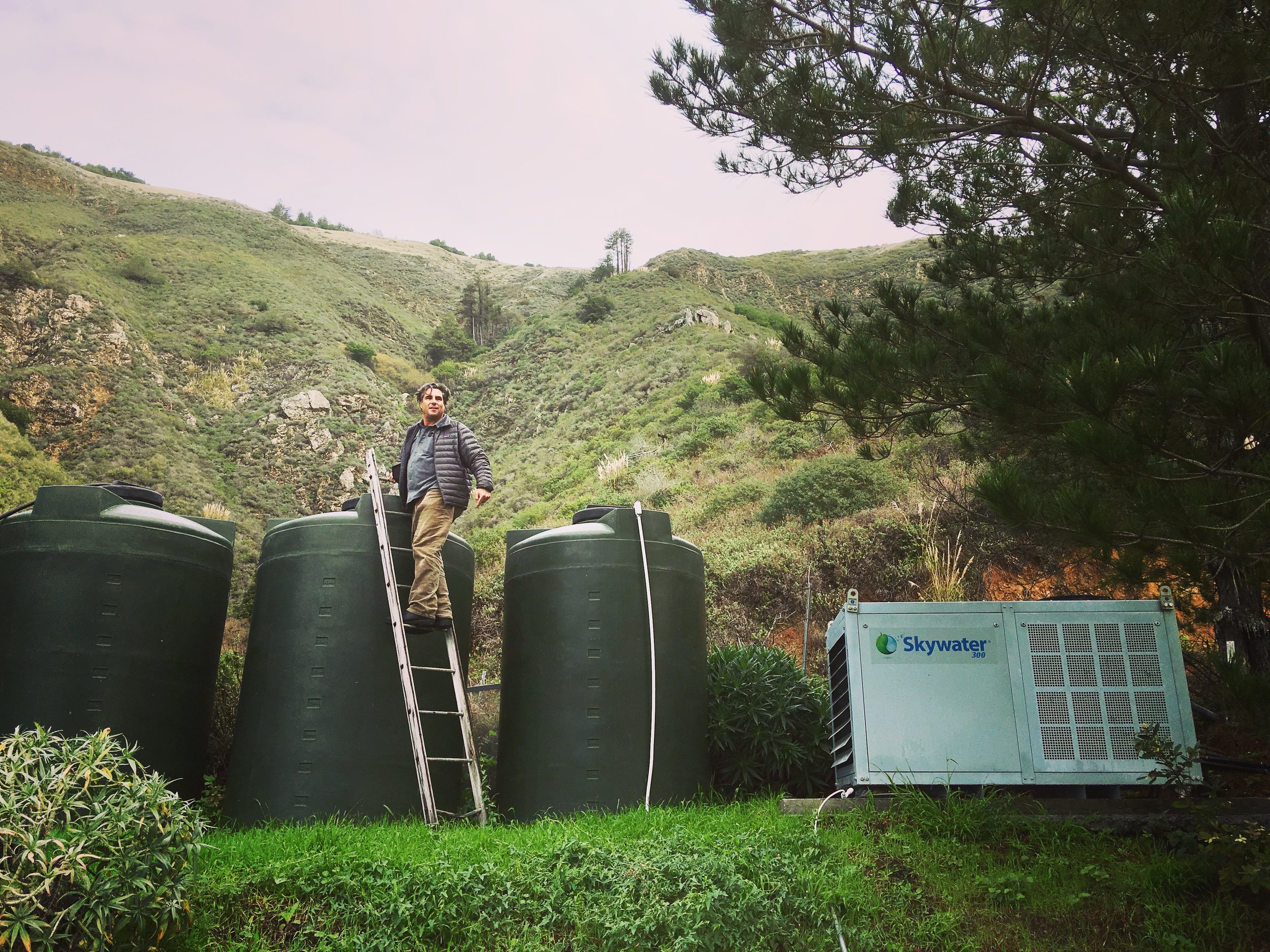 David Hertz harvesting water in Big Sur, California. Skywater 150 produces up to 150 gallons a day, and the water can be stored in water collection tanks for future use. (Photo courtesy Skysource.org)