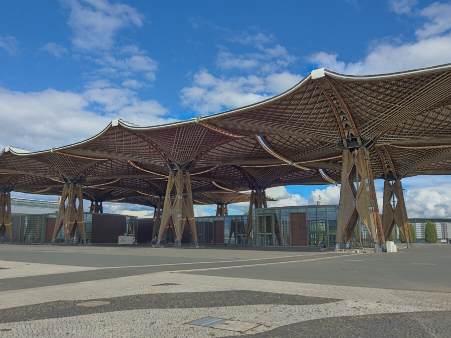 Illustrates large-scale engineered glulam and veneer timber canopy construction spanning broad areas, demonstrating commercial timber roof engineering.