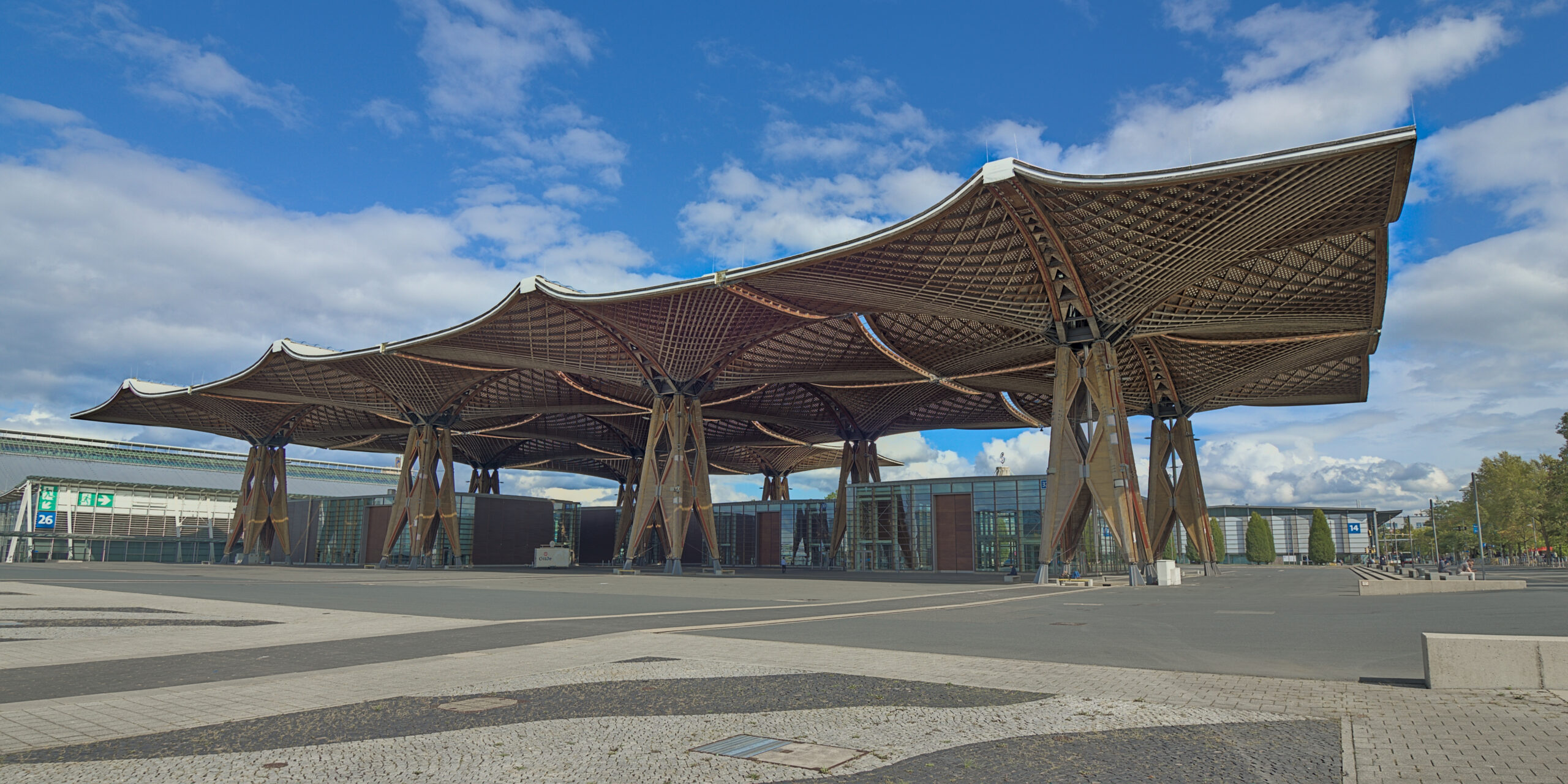 Illustrates large-scale engineered glulam and veneer timber canopy construction spanning broad areas, demonstrating commercial timber roof engineering.