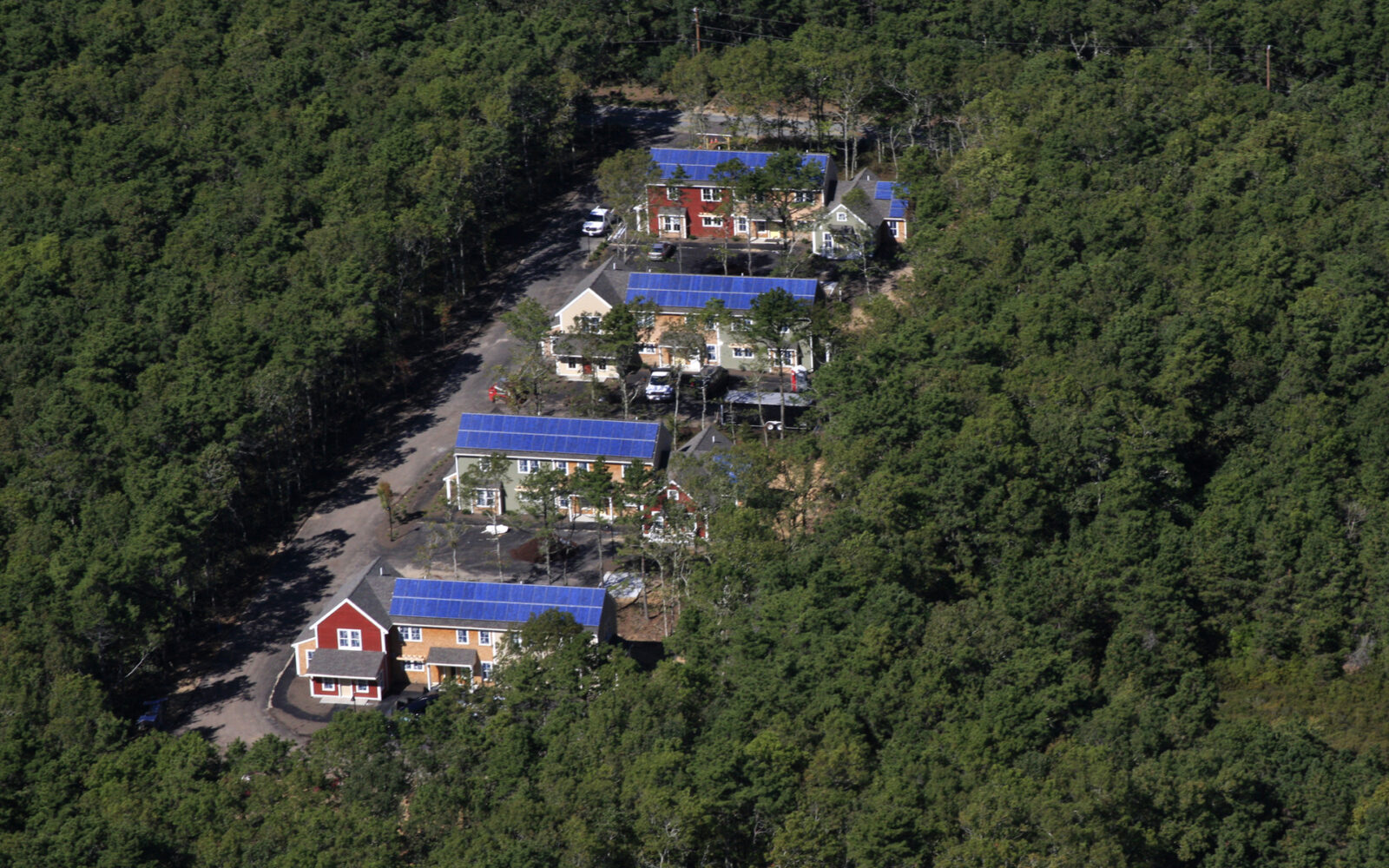 This U.S. Department of Energy photograph documents a rooftop solar installation completed for Habitat for Humanity (in Harwich, Massachusetts), illustrating the core intersection of affordable homebuilding and clean energy deployment.