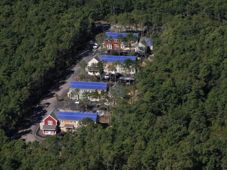 This U.S. Department of Energy photograph documents a rooftop solar installation completed for Habitat for Humanity (in Harwich, Massachusetts), illustrating the core intersection of affordable homebuilding and clean energy deployment.