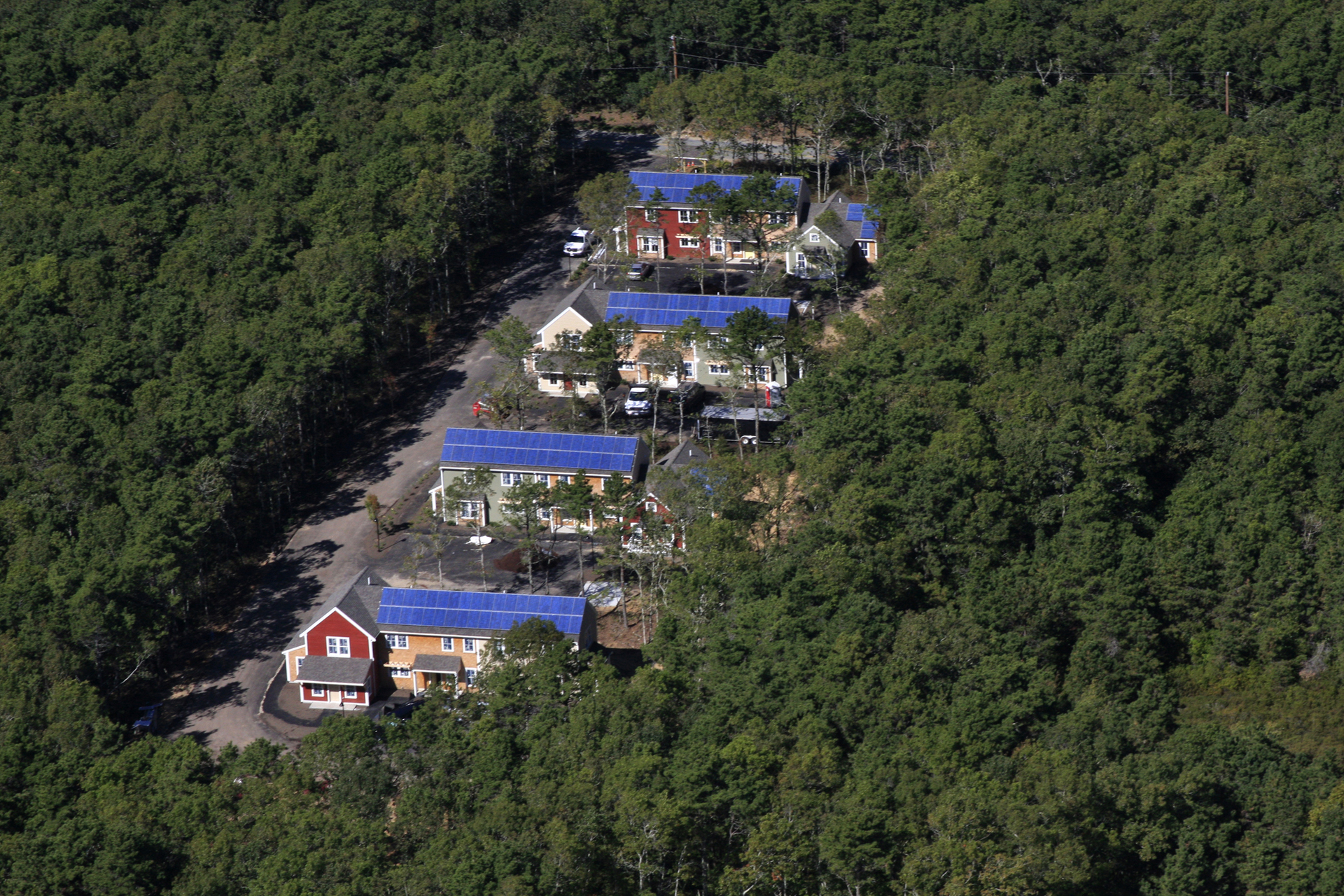 This U.S. Department of Energy photograph documents a rooftop solar installation completed for Habitat for Humanity (in Harwich, Massachusetts), illustrating the core intersection of affordable homebuilding and clean energy deployment.